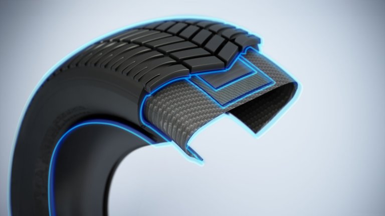 A detailed cross-section of a tire showcasing its tread pattern and internal structure, highlighted with blue outlines
