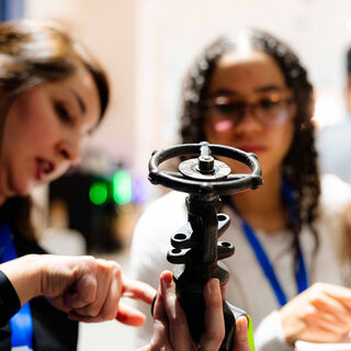 2025 Sustainability Report cover featuring three women inspecting a spare part