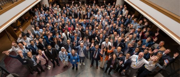 A picture of FCC Forum's participants, all raising their hands to celebrate
