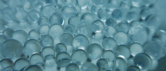 Close-up of silica-based supports and catalysts with translucent beads reflecting light
