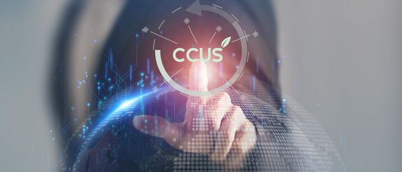 A person interacting with digital elements, highlighting "CCUS" technology, surrounded by a digital world