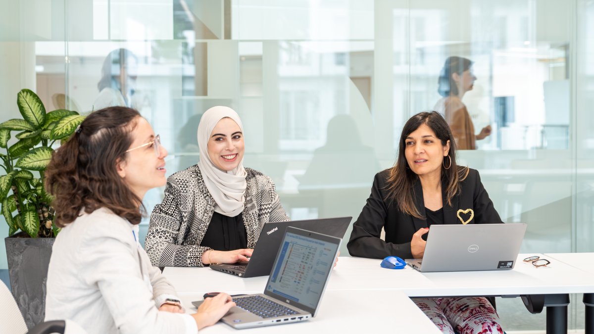 Three Technip Energies employees sitting in a boardroom