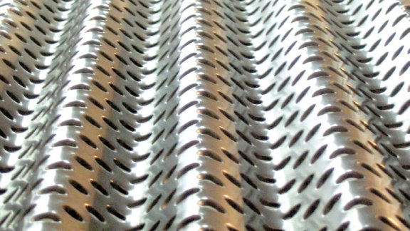 Rippletray (Close-up of a metallic surface with perforated patterns)