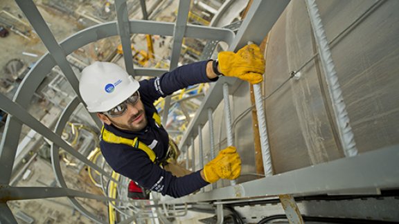 T.EN Burgas man on ladder on construction site