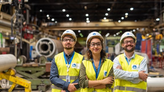 Three Technip Energies employees onsite wearing safety gear