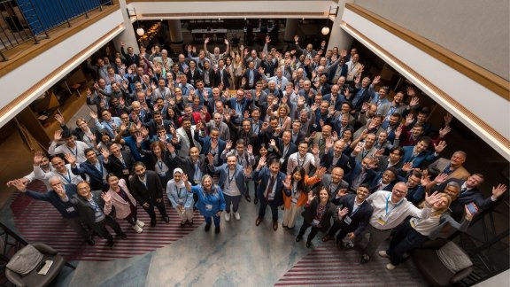A picture of FCC Forum's participants, all raising their hands to celebrate