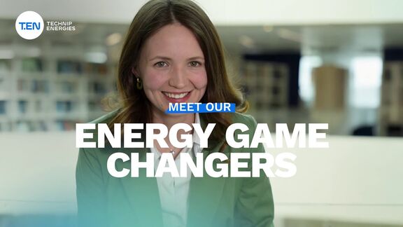Person in a green blazer seated indoors of an office and the text ‘Energy Game Changers’ displayed.