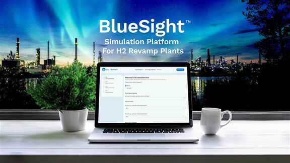 Laptop displaying the BlueSight simulation platform on a desk , set against a night-time industrial plant backdrop with blue aurora‑like lights.