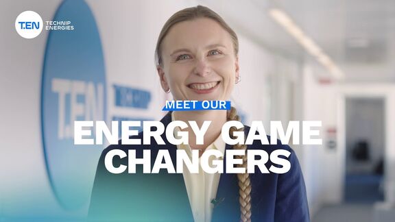 Person standing in a hallway near a TEN Technip Energies sign, with the text ‘Energy Game Changers’ displayed