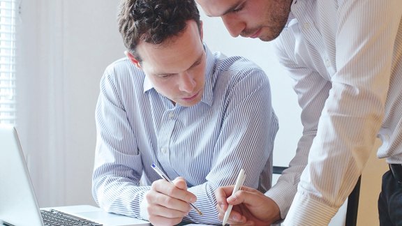 Two colleagues working together on a document